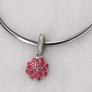 Macro view of a pink floral charm with rhinestones and matte finish texture details