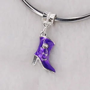 Macro view of a purple enamel boot charm with a sparkling rhinestone on a metal bead
