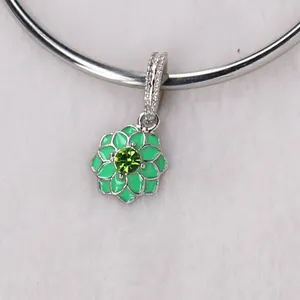 Macro shot of green enamel double flower petal pendant with green crystal center