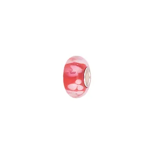 Macro view of a deep pink glass charm bead featuring delicate white floral patterns