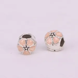 Detail of DIY silver alloy cherry blossom beads with pink enamel for charm bracelets
