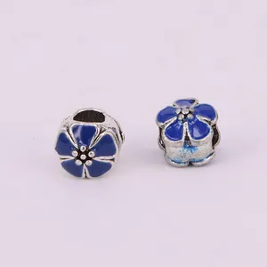 Detailed macro shot of blue enamel cherry blossom beads with large holes for DIY jewelry