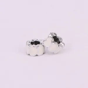 Macro view of heart-shaped hollow charms with white enamel coating for DIY bracelets