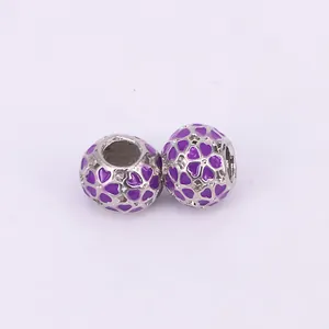 Silver bead charm with purple enamel hearts and sparkling zircon stones on white background