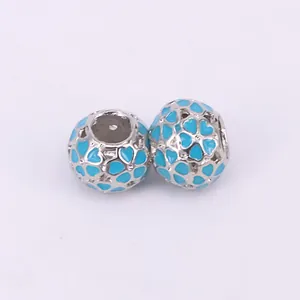 Macro detail of silver hollow heart beads with light blue enamel for DIY bracelets