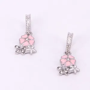Close-up of pink cherry blossom earrings with enamel flower and sparkling zirconia stones