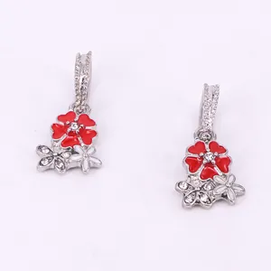 Detail of red and white enamel cherry blossom pendants with sparkling crystals