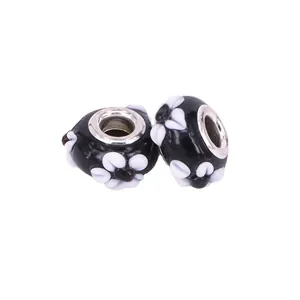 Set of two black lampwork glass beads with white floral patterns and silver core for DIY