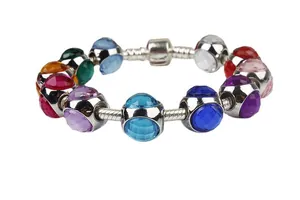 Macro shot of colorful faceted crystal beads on a silver snake chain bracelet