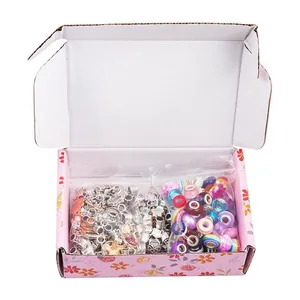 Detailed view of DIY jewelry charm set with assorted beads and floral gift box packaging