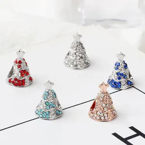 Detailed view of DIY Christmas tree charms with colorful rhinestones for bracelets