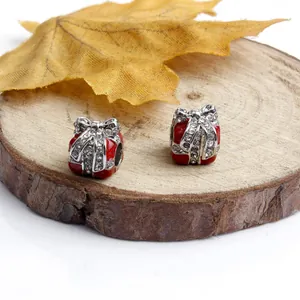 Detail of red enamel gift box beads with sparkling rhinestones for DIY charm bracelets