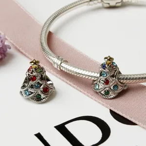 Macro view of Christmas tree charms with colorful rhinestones on a silver snake chain