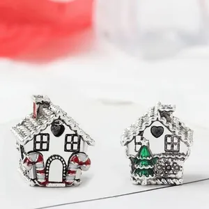 Detail showing two Christmas house charms with red and green enamel on silver alloy beads