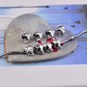 Detail of vintage silver leaf charms and snake chain for DIY jewelry making