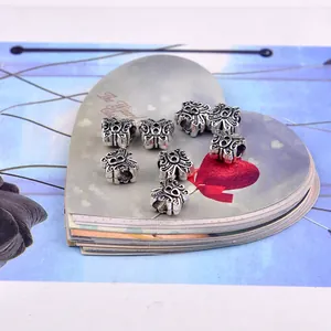 Detailed view of vintage silver butterfly spacer beads with embossed texture for DIY jewelry
