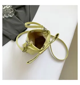 Internal view of mini pearl handbag with magnetic closure and bow knot design