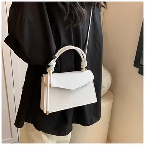 Chic white lychee textured crossbody bag with knotted handle and golden hardware