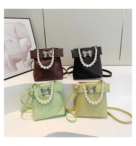 Detailed display of four elegant bags with pearl handles and silver bow accents