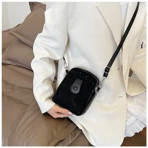 Close-up of black rhinestone mini crossbody phone bag with silver hardware and chain strap