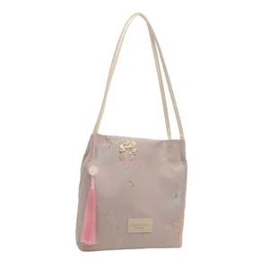 Floral brocade tote bag with pink tassels and gold butterfly patterns for fashion women