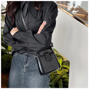 Detail of black rhinestone mini crossbody bag with shimmering silver crystal accents