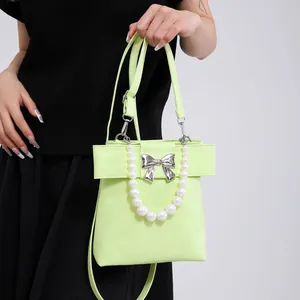 Chic light green crossbody bag with pearl handle and silver bow buckle for women