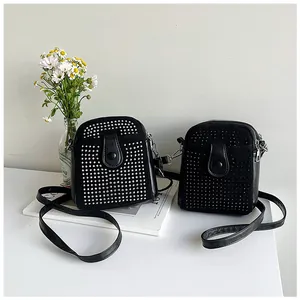 Detail of black mini crossbody bags with decorative silver studs and sleek leather textures