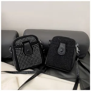Detail of black mini crossbody bags with silver rhinestones and punk rivet studs