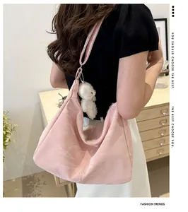 Pink faux leather tote bag with cute bear charm shown on model in a cozy interior