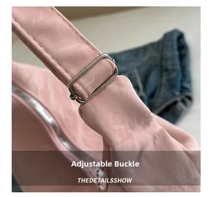 Detailed close-up of pink tote bag showing adjustable metal buckle and strap stitching