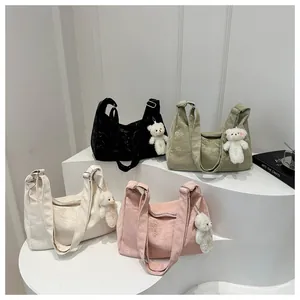Detailed collection of colorful tote bags with plush bear charms and wide shoulder straps