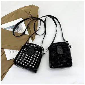 Detail view of black PU leather mini bags with silver and black rivet studs decoration