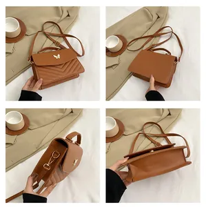 Detail view of caramel crossbody bag with V-quilted texture and butterfly metal ornament