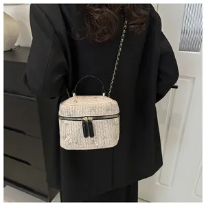 Detailed embroidery and straw texture on box bag with chain strap and top handle