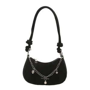 Black half-moon underarm bag with silver chain and star-heart charms on white background