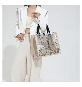 Detail of transparent tote bag with black line art and beige canvas side panels