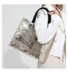 Detail of transparent PVC tote bag with linen base and artistic floral windmill print