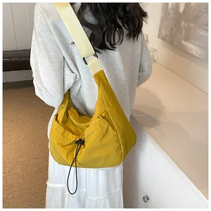 Bright yellow dumpling crossbody bag with adjustable wide shoulder strap for casual wear