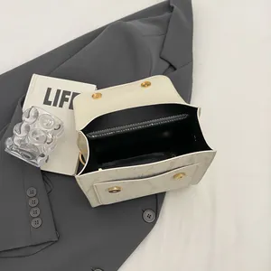 Chic cream leather shoulder bag with gold magnetic buckle and dual interior compartments