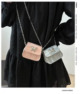 Detail showing pink and silver mini chain bags with metallic butterfly ornaments