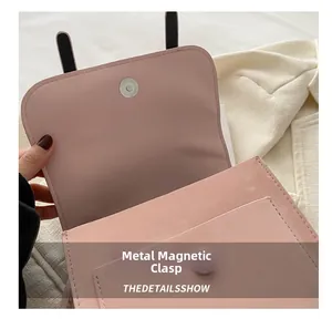 Detailed close-up of pink PU leather backpack featuring a durable metal magnetic snap closure