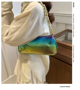 Iridescent Y2K underarm bag with chunky gold chain strap worn by a model in a trendy style