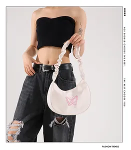 Detail of white crescent shoulder bag with pink butterfly embroidery and ruched strap