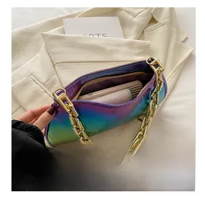 Internal view of iridescent baguette bag showing space for phone and gold chain