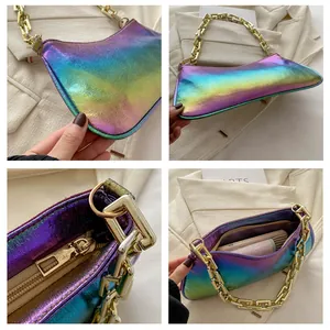 Detail of holographic handbag showing its iridescent texture and thick gold chain strap