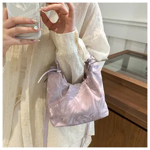 Detail of light purple pleated cloud bag featuring marble pattern and drawstring closure