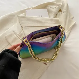 Iridescent holographic baguette underarm bag with thick gold chain strap and interior space