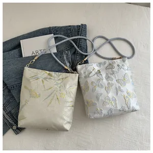 Detail view of high-density jacquard embroidery with bamboo and butterfly patterns on bags