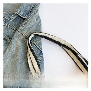 Detail shot of the comfortable woven strap on a black and white striped tote bag